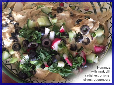 Hummus with mint, dill, radishes, onions, olives, cucumbers