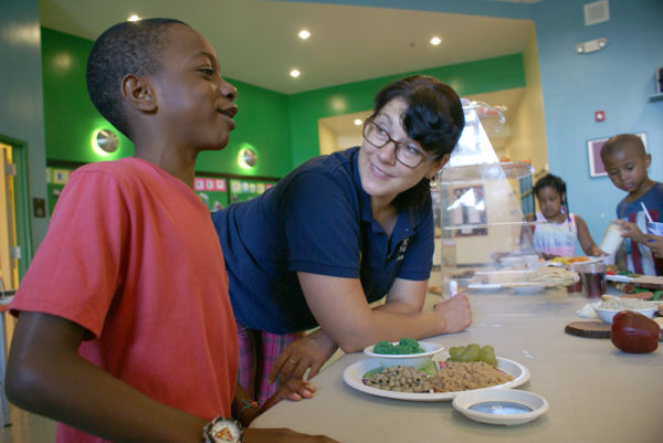 Adriene talks nutrition with kids at a GBFB Nutrition Fair.