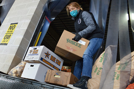 Partner agency loading a truck with food.