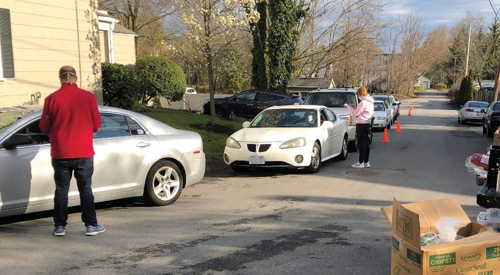 Volunteers taking orders at drive-up pantry