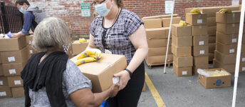 A woman receiving food at a GBFB partner agency