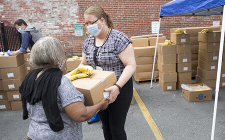 A woman receiving food at a GBFB partner agency