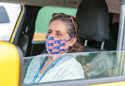 Woman waiting in her car to receive food