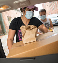 Client loading food into her car