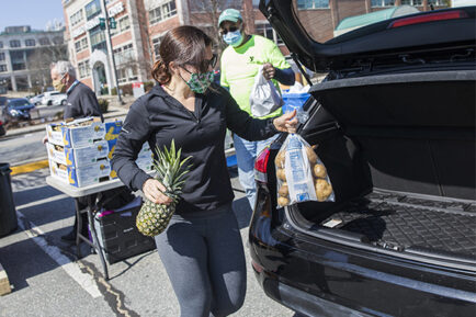 Loading food into a car at a mobile food distribution site