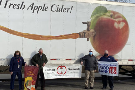 Smiling for a picture in front of a Carlson Orchards truck