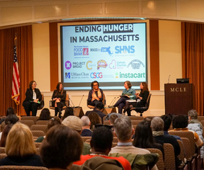 Panel of five speakers with Ending Hunger in Massachusetts sign