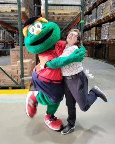 Red Sox Wally and person in warehouse