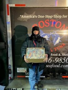 man holding box of frozen seafood