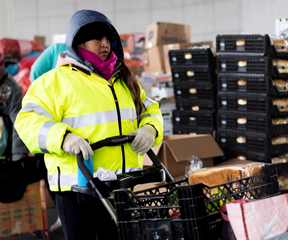 Woman pushing cart at food distribution