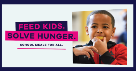A young boy eats an apple slice. Feed Kids. Solve Hunger. School Meals for All. 
