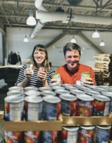 Wildgrain team assembling family meal boxes during a volunteer visit to GBFB
