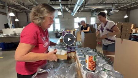 Female volunteer packing boxes in The Greater Boston Food Bank Warehouse