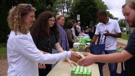 Staff and students distributing food at a free Mobile Market on the campus of Mass Bay Community College