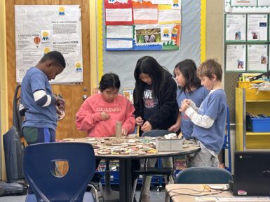 Students creating ornaments in the classoom for fundraiser